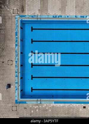 Aerial view of a clean and modern public swimming pool with blue water and geometric patterns, Oberschoneweide, Germany. Stock Photo