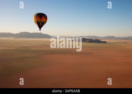 Aerial view of The hot-air balloon shortly before take-off in the light of the early morning. Namib Desert, NamibRand Nature Reserve, Namibia. Stock Photo