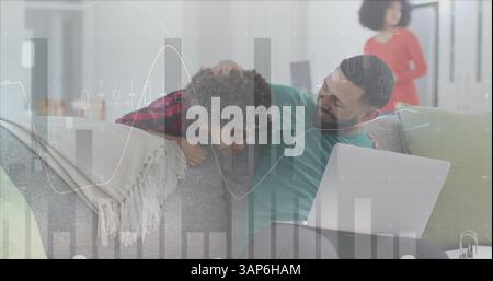 Image of statistics and data processing over man and son using laptop Stock Photo