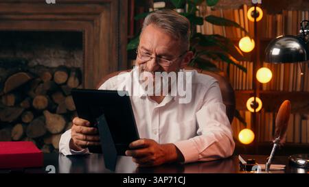 Caucasian old man photography memories looking photo nostalgia senior positive emotion smiling aged grandfather history businessman nostalgic frame Stock Photo