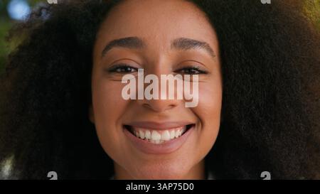 Close up face African American woman smiling laughing positive funny female girl businesswoman portrait happy student lady health teeth smile looking Stock Photo