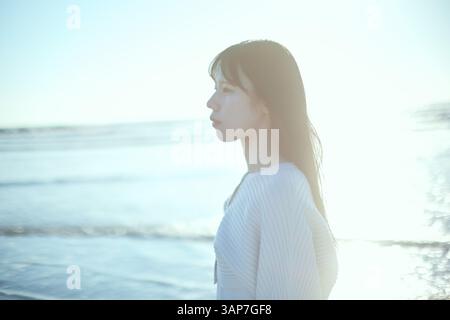 Young Japanese woman at the beach Stock Photo