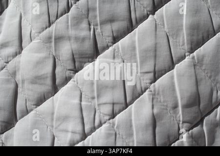 Close up of white quilted fabric textured background Stock Photo