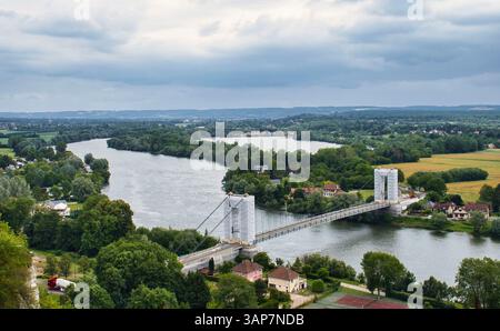 Les Andelys, France - June 23, 2021: Les Andelys suspension bridge over the Seine on a cloudy summer day in Normandy, France. Stock Photo