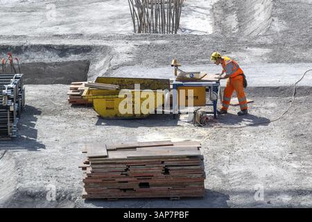Construction site Construction worker Circular saw Stock Photo