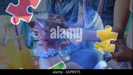 Image of colourful puzzle pieces and human head over children using tablets Stock Photo