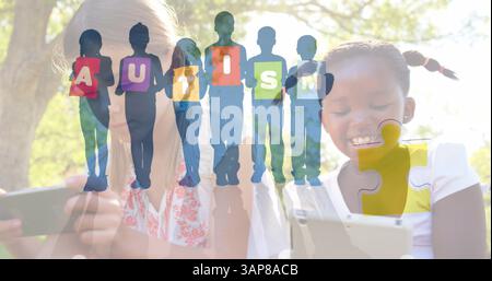 Image of colourful puzzle pieces and autism text over schoolgirls using tablets Stock Photo