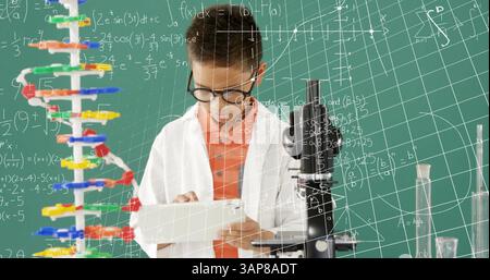 Image of mathematical formulae over smiling schoolboy using tablet Stock Photo