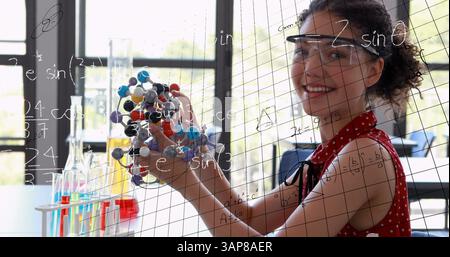 Image of mathematical formulae over smiling student Stock Photo