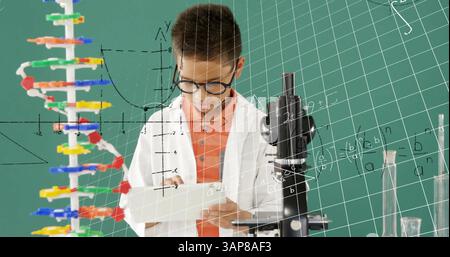 Image of mathematical formulae over smiling schoolboy using tablet Stock Photo