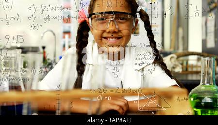 Image of mathematical formulae over smiling schoolgirl Stock Photo