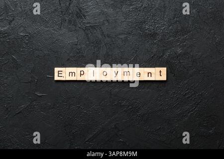 Employment word written on wood block. Employment text on cement table for your desing, Top view concept. Stock Photo