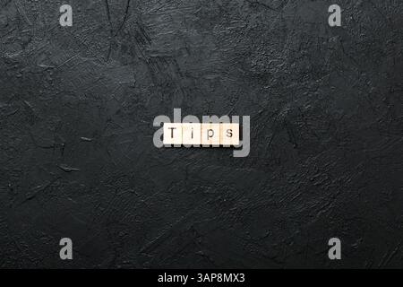 tips word written on wood block. tips text on table, concept. Stock Photo