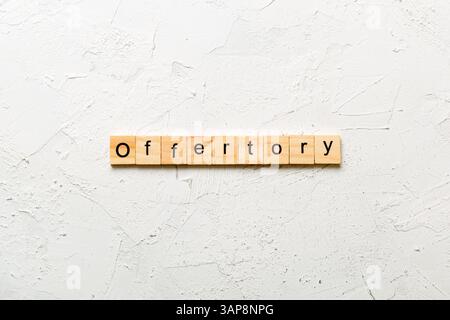 offertory word written on wood block. offertory text on table, concept. Stock Photo