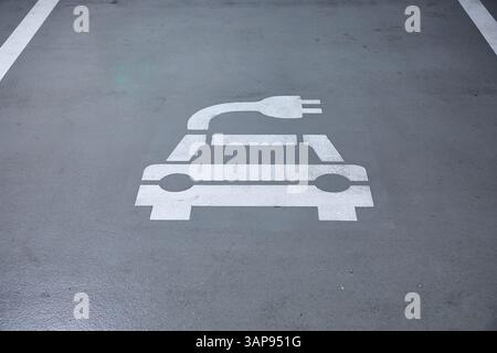 Electric car charging station in a carpark Stock Photo