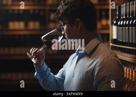 Man Tasting Wine in Wine Cellar Stock Photo