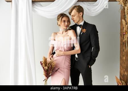 A happy couple enjoys a romantic moment at their spring wedding amid lovely decorations. Stock Photo