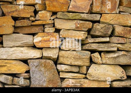 View of the brickwork. View of a brick fence made from many different stones. Stock Photo
