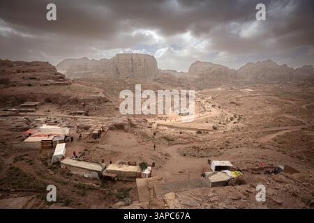 Dramatic clouds gathering over petra valley in jordan with souvenir stalls Stock Photo