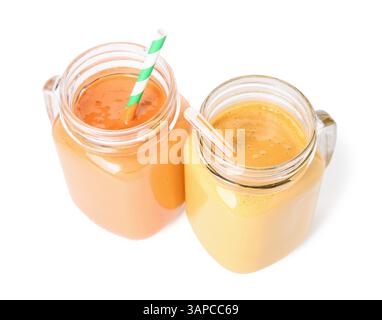 Mason jars of different tasty smoothie with straws on white background Stock Photo