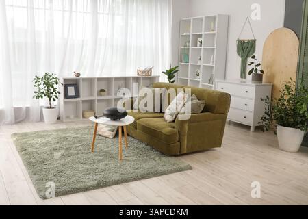 Interior of living room with green sofa and glucophone on table Stock Photo
