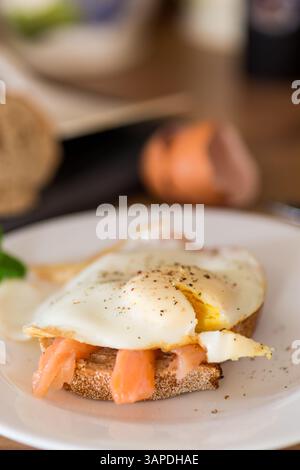 Diet breakfast with cooked egg and lightly salted red fish. Stock Photo