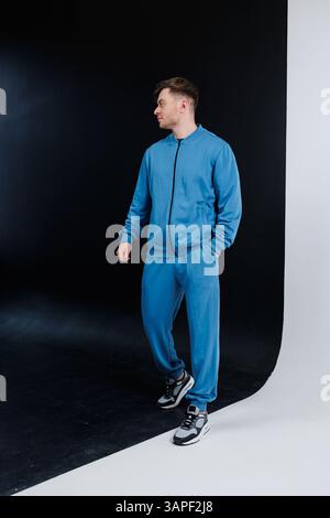 A model showcasing a trendy blue tracksuit, perfect for sports and casual outings. Comfortable fit ideal for workouts or relaxed days Stock Photo