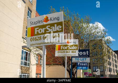 Slough, UK. 16th April, 2025. Estate Agent for sale signs outside a block of flats in Slough, Berkshire. The Government has announced the UK Price Index for February. The report said "In England the February data shows, on average, house prices rose by 0.3% since January 2025. The annual price rise of 5.3% takes the average property value to £292,000". Credit: Maureen McLean/Alamy Live News Stock Photo