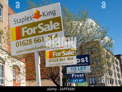 Slough, UK. 16th April, 2025. Estate Agent for sale signs outside a block of flats in Slough, Berkshire. The Government has announced the UK Price Index for February. The report said "In England the February data shows, on average, house prices rose by 0.3% since January 2025. The annual price rise of 5.3% takes the average property value to £292,000". Credit: Maureen McLean/Alamy Live News Stock Photo