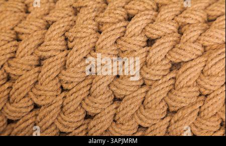Knitted product of brown woolen threads, close-up. Knitted pattern. Stock Photo