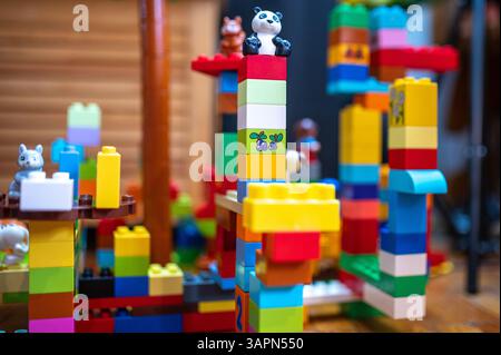 April -15 2025- Bucharest Romania-Lego pieces with little people building multicolored towers.Selective focus. Stock Photo