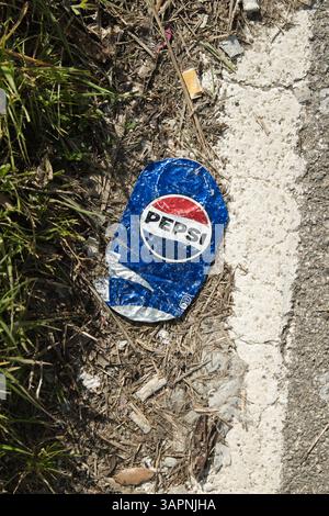 Pepsi cola can crushed on the asphalt, isolated Stock Photo