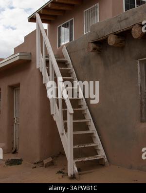 Oct 23, 2010 - Acoma Pueblo, New Mexico, U.S. - A traditional three-pole white wooden kiva ladder provides access to the Acoma Pueblo's ceremonial kiva used for religious ceremonies. Unlike most underground Southwest kivas, Acoma's are above ground, as digging into the mesa's solid rock isn't possible. A Native American pueblo, also known as 'Sky City', it is built on top of a 367-foot (112 m) sandstone mesa. Settled around 1100, it is one of the oldest continuously inhabited communities in the U.S. Located 60 m. (100 km) west of Albuquerque, Acoma Pueblo was named the 28th National Trust for Stock Photo
