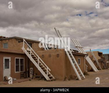 Oct 23, 2010 - Acoma Pueblo, New Mexico, U.S. - A traditional three-pole white wooden kiva ladder provides access to the Acoma Pueblo's ceremonial kiva used for religious ceremonies. Unlike most underground Southwest kivas, Acoma's are above ground, as digging into the mesa's solid rock isn't possible. A Native American pueblo, also known as 'Sky City', it is built on top of a 367-foot (112 m) sandstone mesa. Settled around 1100, it is one of the oldest continuously inhabited communities in the U.S. Located 60 m. (100 km) west of Albuquerque, Acoma Pueblo was named the 28th National Trust for Stock Photo