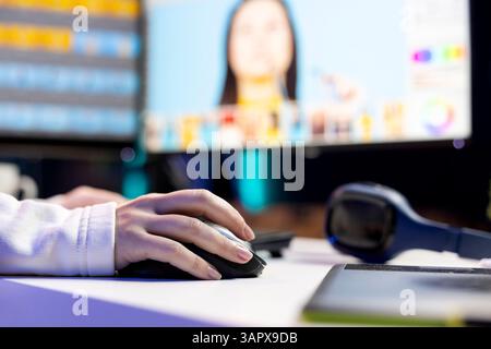 Photo editor color correcting photographs in creative studio using mouse and keyboard, close up shot. Photographer selecting best pictures for editorial content using retouching software Stock Photo