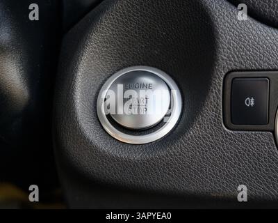 A silver button with the word engine on it. The button is black and white Stock Photo