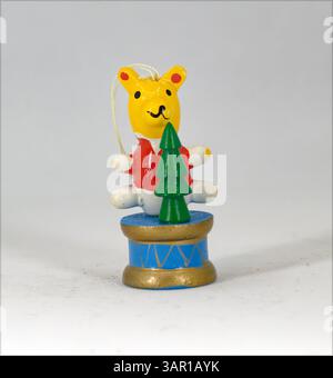 Wooden Teddy bear on a drum decoration on a plain white background Stock Photo