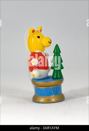 Wooden Teddy bear on a drum decoration on a plain white background Stock Photo