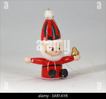 Hanging Father Christmas in wood for a Christmas tree decoration on a plain white background. Stock Photo