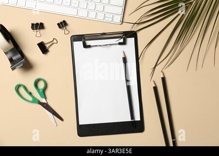 Flat lay composition with clipboard and blank paper on beige background. Space for text Stock Photo