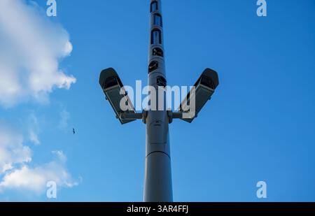 Security cameras on a tall streetlight against blue sky at Museum Island in Berlin-Mitte, Germany, symbolizing urban surveillance. Stock Photo