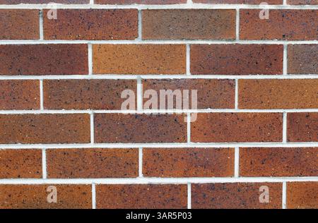 Close up textured background of a red-brown brick wall with white mortar Stock Photo