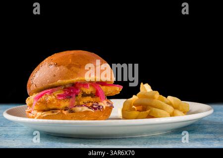 Delicious chicken burger with french fries on a white porcelain plate Stock Photo