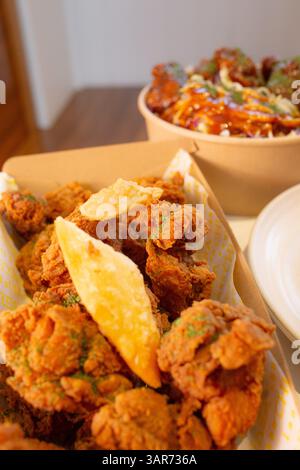 Close-up of deep-fried boneless chicken pieces with deep-fried glass noodle dumplings. Stock Photo