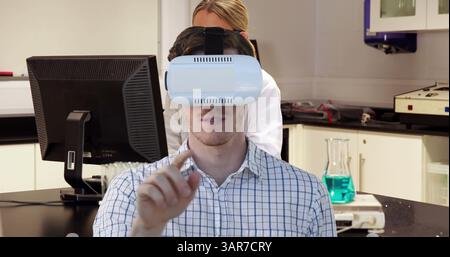 Image of man wearing vr headset over female scientist using computer Stock Photo