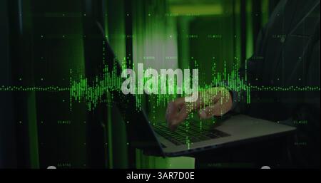 Image of data processing over asian it technician using laptop by computer servers Stock Photo
