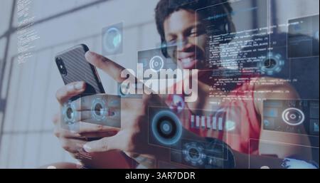 Image of digital screens over smiling biracial man using smartphone Stock Photo