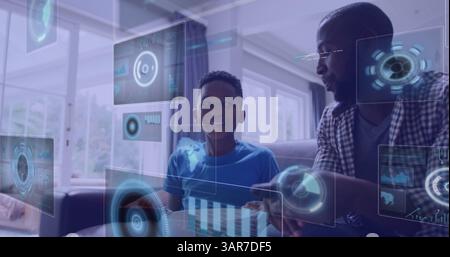 Image of digital screens over smiling african american father with son watching tv Stock Photo