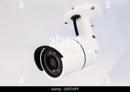 CCTV camera on the hull of an expensive motor yacht. CCTV camera white on a white body. Stock Photo