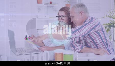 Image of diverse data and clock over caucasian female and male colleagues working at computer Stock Photo